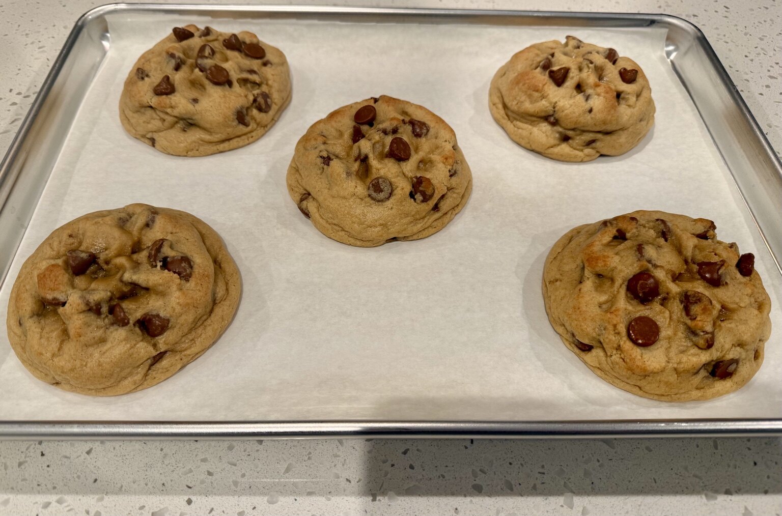 Freshly baked Classic chocolate chip cookies cooling on a tray